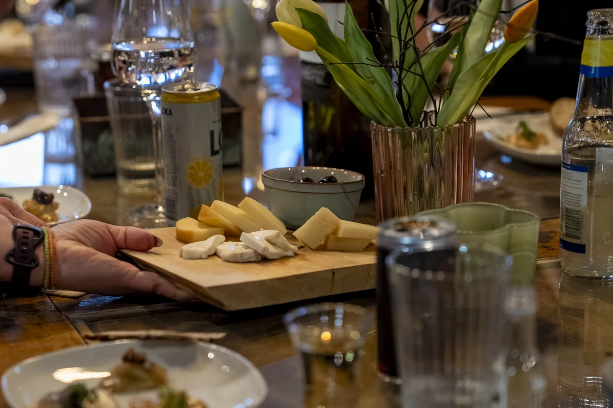A rustic appetiser plate with cured fish, rye bread and pickled vegetables